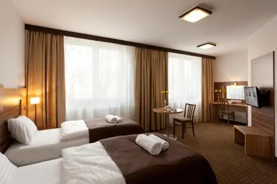 Łóżko lub łóżka w pokoju w obiekcie Hotel Milenium
