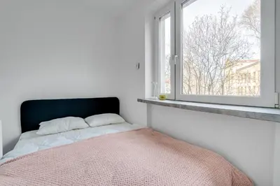 Łóżko lub łóżka w pokoju w obiekcie Pl Orląt Lwowskich 7 by Homeprime