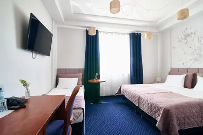 Łóżko lub łóżka w pokoju w obiekcie Hotel Magiczny Zakątek