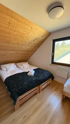 Łóżko lub łóżka w pokoju w obiekcie Domki Wilcza A