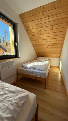 Łóżko lub łóżka w pokoju w obiekcie Domki Wilcza B