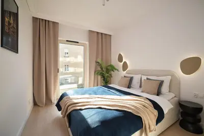 Łóżko lub łóżka w pokoju w obiekcie INA Rent - Apartamenty Czysta Delux