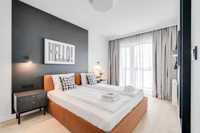 Łóżko lub łóżka w pokoju w obiekcie Rent Invest - Quorum Apartamenty Parking Klimatyzacja