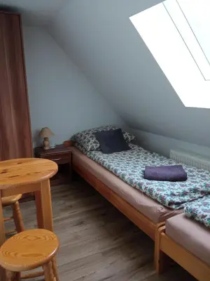 Łóżko lub łóżka w pokoju w obiekcie Siedlisko nad Stawem