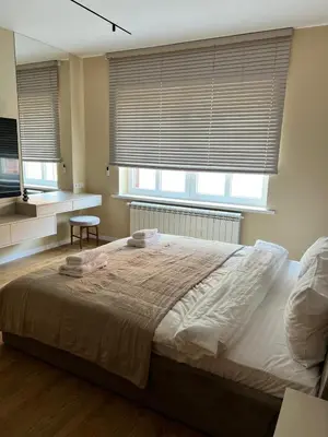 Łóżko lub łóżka w pokoju w obiekcie Noble Apartments