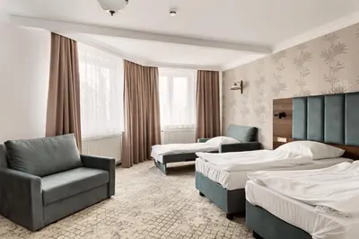 Łóżko lub łóżka w pokoju w obiekcie Hotel Sylwia