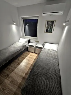 Łóżko lub łóżka w pokoju w obiekcie Apartamenty nad Kamiennym Potokiem 2