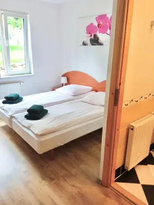 Łóżko lub łóżka w pokoju w obiekcie Leśny Dom