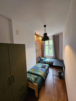 Łóżko lub łóżka w pokoju w obiekcie 7Wygodny pokoj w centrum Wroclawia