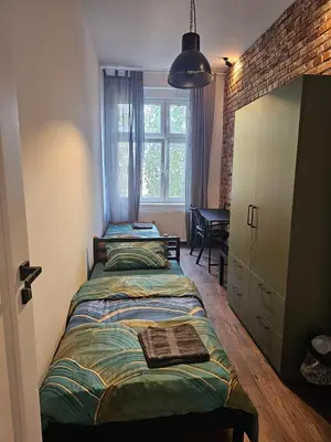 Łóżko lub łóżka w pokoju w obiekcie 8Wygodny pokój w centrum Wrocławia