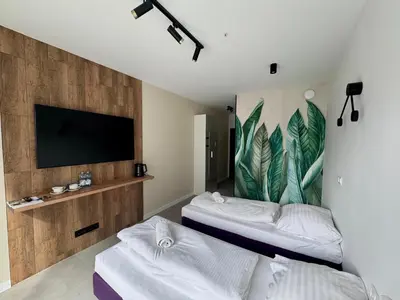 Łóżko lub łóżka w pokoju w obiekcie Mikroapartamenty Garden