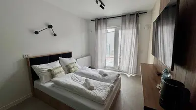 Łóżko lub łóżka w pokoju w obiekcie Mikroapartamenty Garden