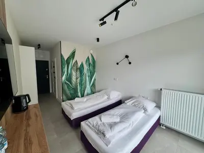 Łóżko lub łóżka w pokoju w obiekcie Mikroapartamenty Garden