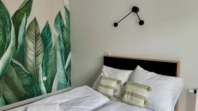 Łóżko lub łóżka w pokoju w obiekcie Mikroapartamenty Garden