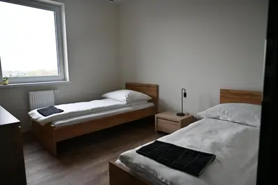 Łóżko lub łóżka w pokoju w obiekcie Apartament Podmiejska