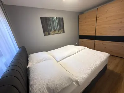 Łóżko lub łóżka w pokoju w obiekcie Apartament Pod Leśnym Niebem