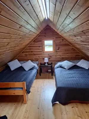 Łóżko lub łóżka w pokoju w obiekcie Domek letni