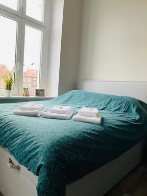 Łóżko lub łóżka w pokoju w obiekcie Apartment Pastelowy