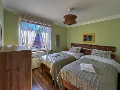 Łóżko lub łóżka w pokoju w obiekcie Kolorowo Kącik - Apartament przy Parku