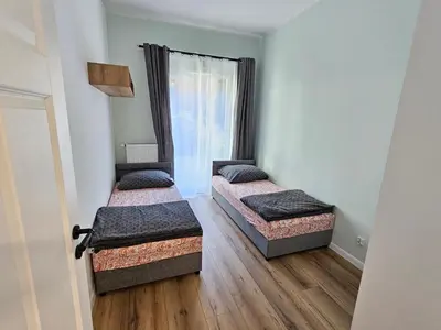 Łóżko lub łóżka w pokoju w obiekcie MADALINSKIEGO Apartament 47