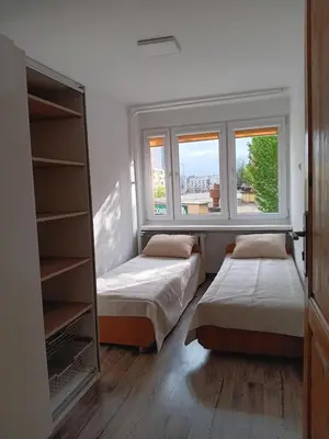 Łóżko lub łóżka w pokoju w obiekcie Apartament IVONA Grabiszynska