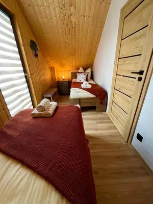 Łóżko lub łóżka w pokoju w obiekcie Brzozowa Osada