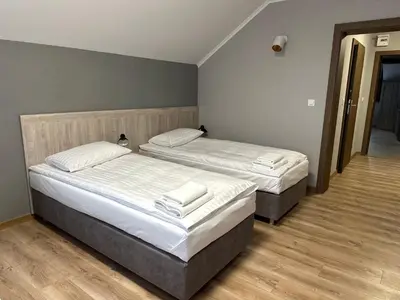Łóżko lub łóżka w pokoju w obiekcie Karczma u Jakuba