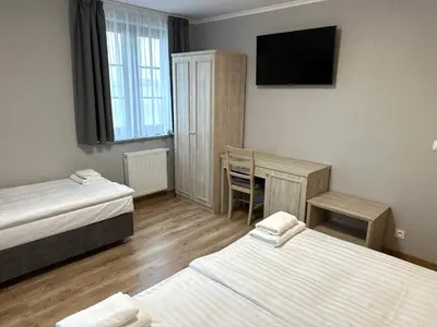 Łóżko lub łóżka w pokoju w obiekcie Karczma u Jakuba