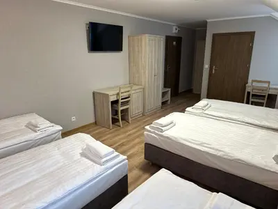 Łóżko lub łóżka w pokoju w obiekcie Karczma u Jakuba