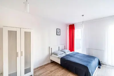 Łóżko lub łóżka w pokoju w obiekcie Red Apartment z Tarasem