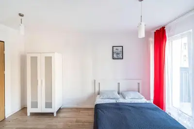 Łóżko lub łóżka w pokoju w obiekcie Red Apartment z Tarasem