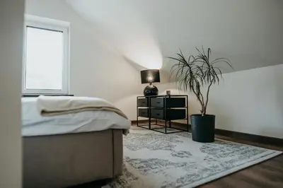 Łóżko lub łóżka w pokoju w obiekcie Castle Lakes - Apartamenty