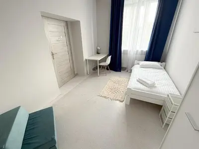 Łóżko lub łóżka w pokoju w obiekcie MobiRooms - Pokoje i Apartamenty