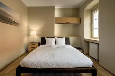 Łóżko lub łóżka w pokoju w obiekcie RentPlanet - Apartament Więzienna