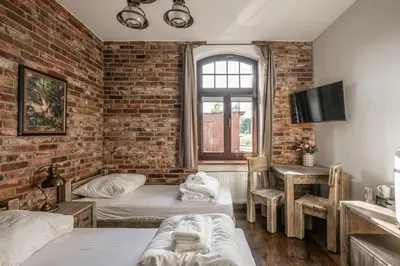 Łóżko lub łóżka w pokoju w obiekcie Stara Przepompownia