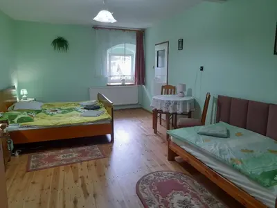 Łóżko lub łóżka w pokoju w obiekcie Lipowy Dwór