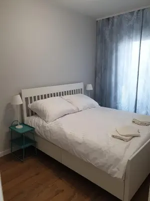 Łóżko lub łóżka w pokoju w obiekcie Apartamenty Kępa Mieszczańska