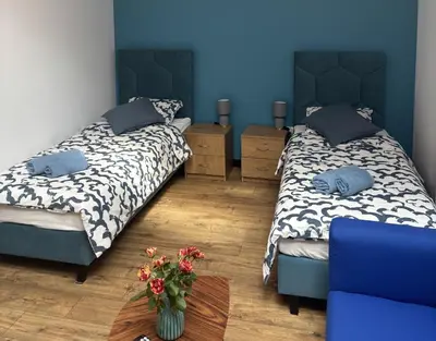 Łóżko lub łóżka w pokoju w obiekcie Nowy Zakątek