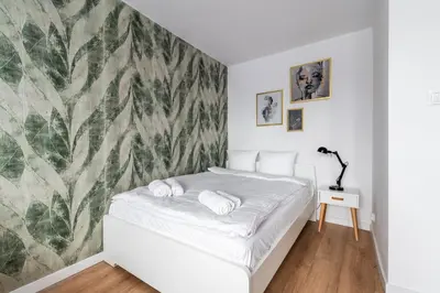 Łóżko lub łóżka w pokoju w obiekcie RentPlanet - Studio Kazimierza Wielkiego