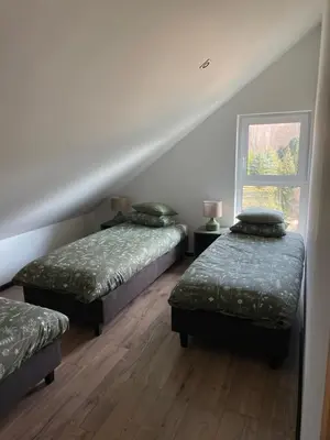 Łóżko lub łóżka w pokoju w obiekcie Domek Na Miodowej