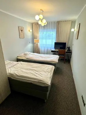 Łóżko lub łóżka w pokoju w obiekcie Grodzka B&B