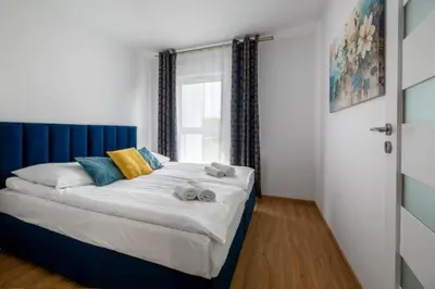 Łóżko lub łóżka w pokoju w obiekcie Apartament Blue