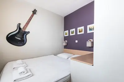 Łóżko lub łóżka w pokoju w obiekcie Samba Apartment