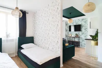 Łóżko lub łóżka w pokoju w obiekcie Katedralna Apartamenty