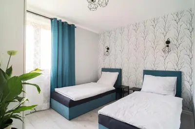 Łóżko lub łóżka w pokoju w obiekcie Katedralna Apartamenty
