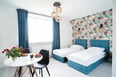 Łóżko lub łóżka w pokoju w obiekcie Katedralna Apartamenty