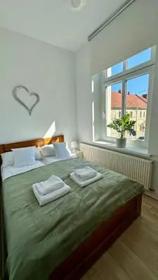 Łóżko lub łóżka w pokoju w obiekcie Przytulny i słoneczny apartament nr 1 Góry Sowie, Jezioro, Centrum
