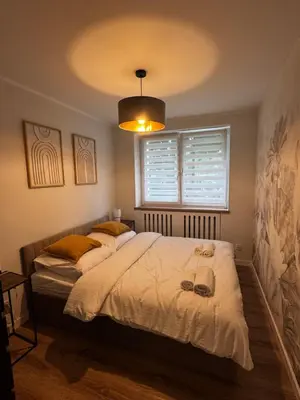 Łóżko lub łóżka w pokoju w obiekcie Malczewskiego 2