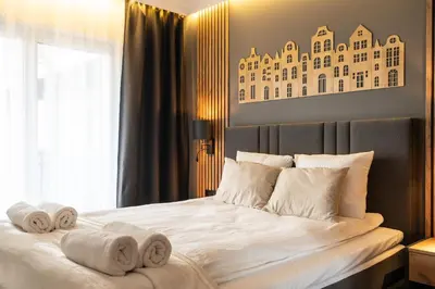 Łóżko lub łóżka w pokoju w obiekcie RentPlanet - Sienkiewicza Residence