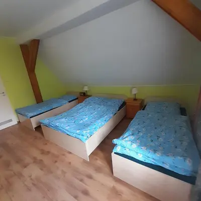 Łóżko lub łóżka w pokoju w obiekcie Górska Perła Pokoje Gościnne
